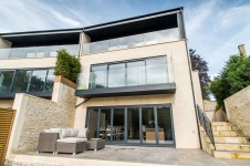 Modern, contemporary terrace featuring aluminium windows and doors